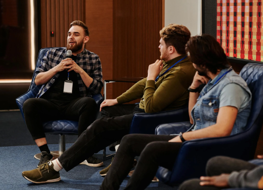 A person sharing their opinion in a group of people