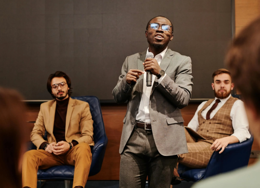 A person expressing his opinion to a group of people